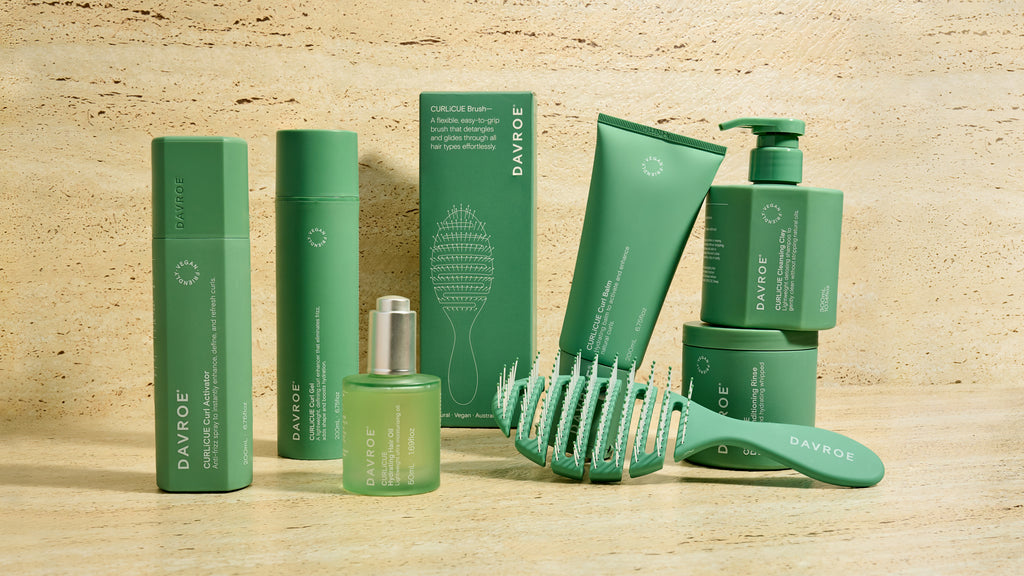 Set of green Davroe hair care products on a wooden surface