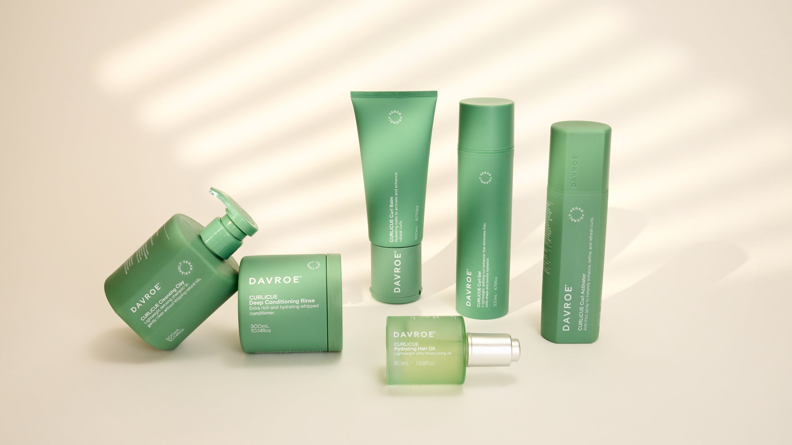 Set of green haircare products with Davroe branding on a beige background
