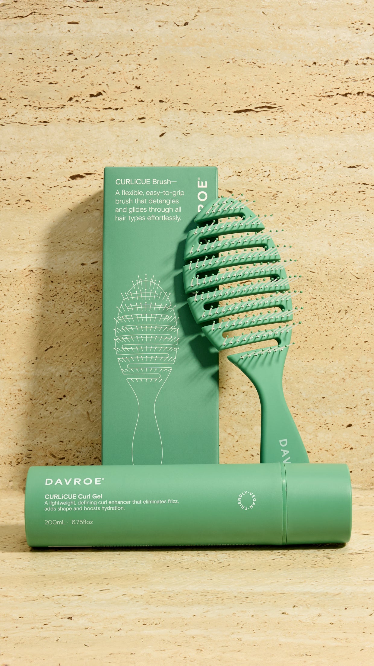 Green hairbrush and packaging on a beige background
